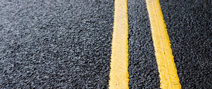 image of a tarmac road with yellow road markings