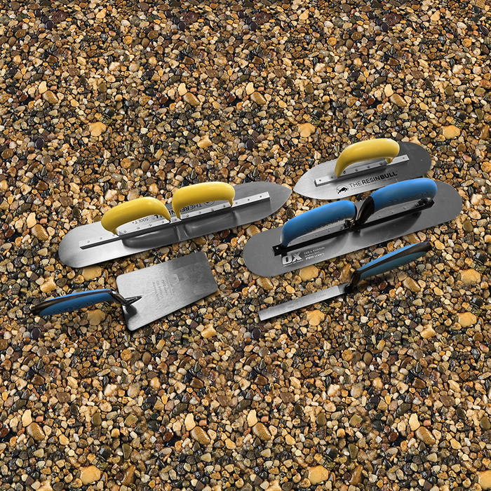 overhead photo of resin bound trowels with yellow and blue handles for resin bound installation